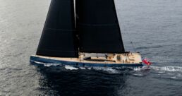 SARISSA Sailing Yacht. Luxury yacht sailing on ocean with black sails.