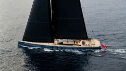 SARISSA Sailing Yacht. Luxury yacht sailing on ocean with black sails.