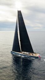 Sailboat gliding on calm ocean waters.