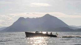 Boat on lake with mountain background. Maserati Tridente Full-Electric Boat