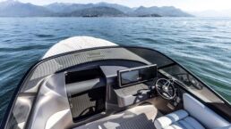 Luxury boat dashboard on calm lake with mountains.. Maserati Tridente Full-Electric Boat