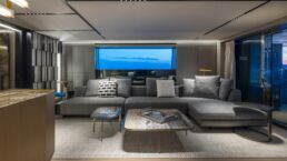 Modern living room with gray sectional sofa. Motor Yacht BEL1