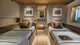 Luxury twin bedroom with sea view window. Navetta 38 Motor Yacht