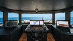 Luxury yacht bridge with navigational screens and ocean view. Navetta 38 Motor Yacht