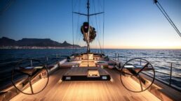 Luxury yacht deck at sunset on the open sea.