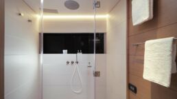 WallyWind110 Modern shower with glass door and towel racks.