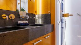 Modern bathroom with wooden cabinets and shower.