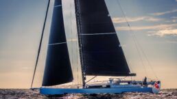 Sailboat cruising on calm ocean at sunset. YYachts Y9 Sailing Yacht