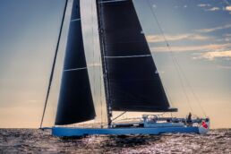 Sailboat cruising on calm ocean at sunset. YYachts Y9 Sailing Yacht