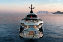 140m Trimaran Motor Yacht Spear. Luxury yacht at sea with distant islands