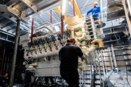 Workers assembling large superyacht engine in factory. Motor Yacht Santosha Heesen Yachts