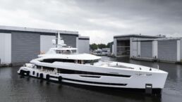 Luxury yacht docked near modern buildings. Motor Yacht Santosha Heesen Yachts