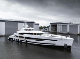 Luxury yacht docked near modern buildings. Motor Yacht Santosha Heesen Yachts