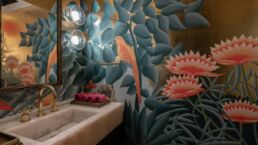 Bathroom with tropical bird-themed wallpaper