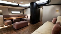 Modern yacht interior with dining area.