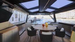 WallyWhy100 Motor Yacht. Luxury yacht interior with round table and chairs.