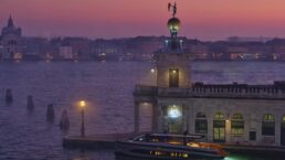 WallyWhy100 Motor Yacht. Venice waterfront at sunset with boat docked.