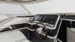 Modern yacht control console with steering wheel.