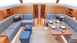 Contest 63CS Sailing Yacht Interior. Luxurious yacht interior with dining table and sofas.