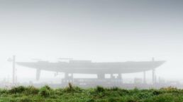 Aquarius Yacht Royal Huisman. Foggy shipyard with grass foreground