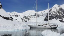 Jagare Sailing Yacht Abeking. Yacht sailing in icy, snowy mountain landscape.