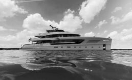 Triple X Vripack Yacht Design. Luxury yacht on calm sea under cloudy sky