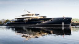 Luxury yacht ONE by Feadship docked in serene waters, sunny day.