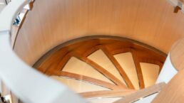 SAN Yacht Interior. Modern wooden spiral staircase, top view